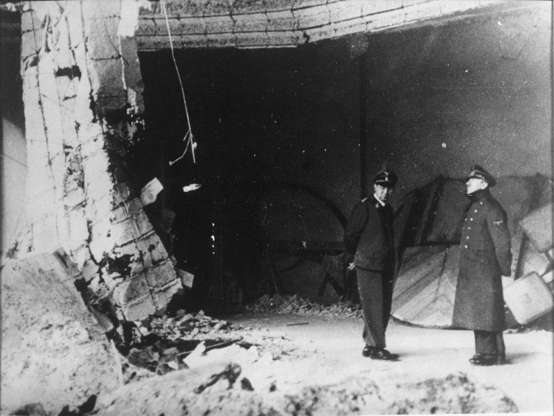 Adolf Hitler observes the ruins of the chancellery with his adjutant Julius Schaub